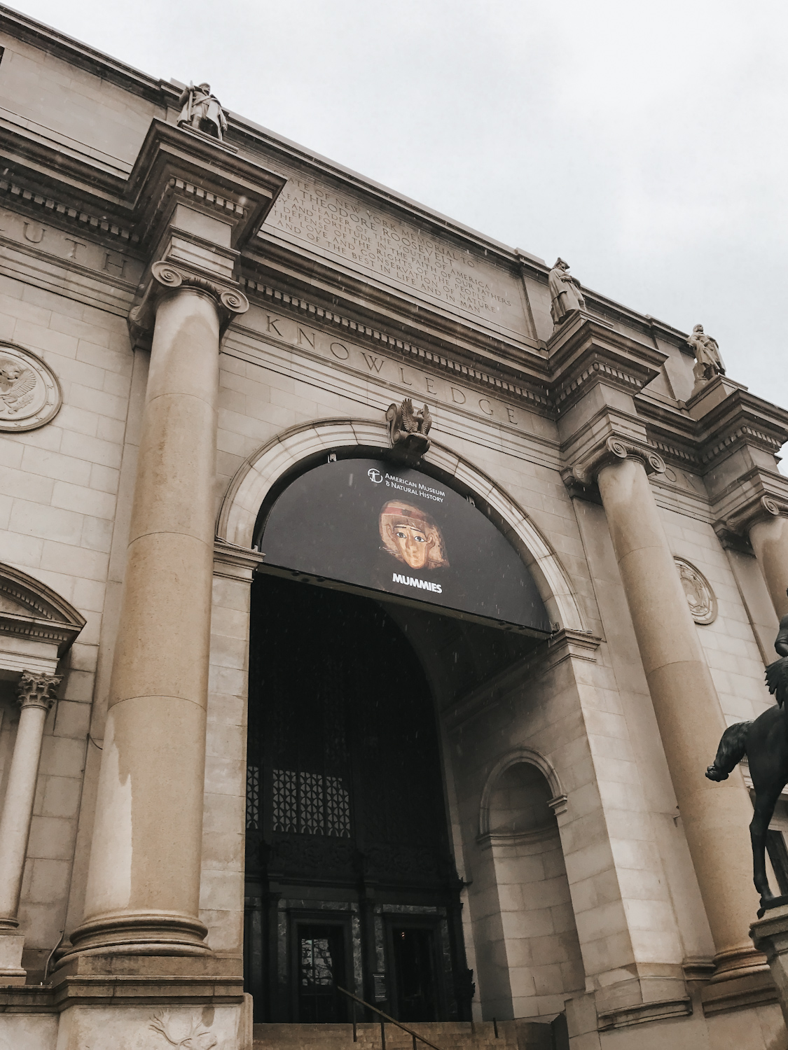 American Museum of Natural History exterior entrance with Mummies exhibition signage New York