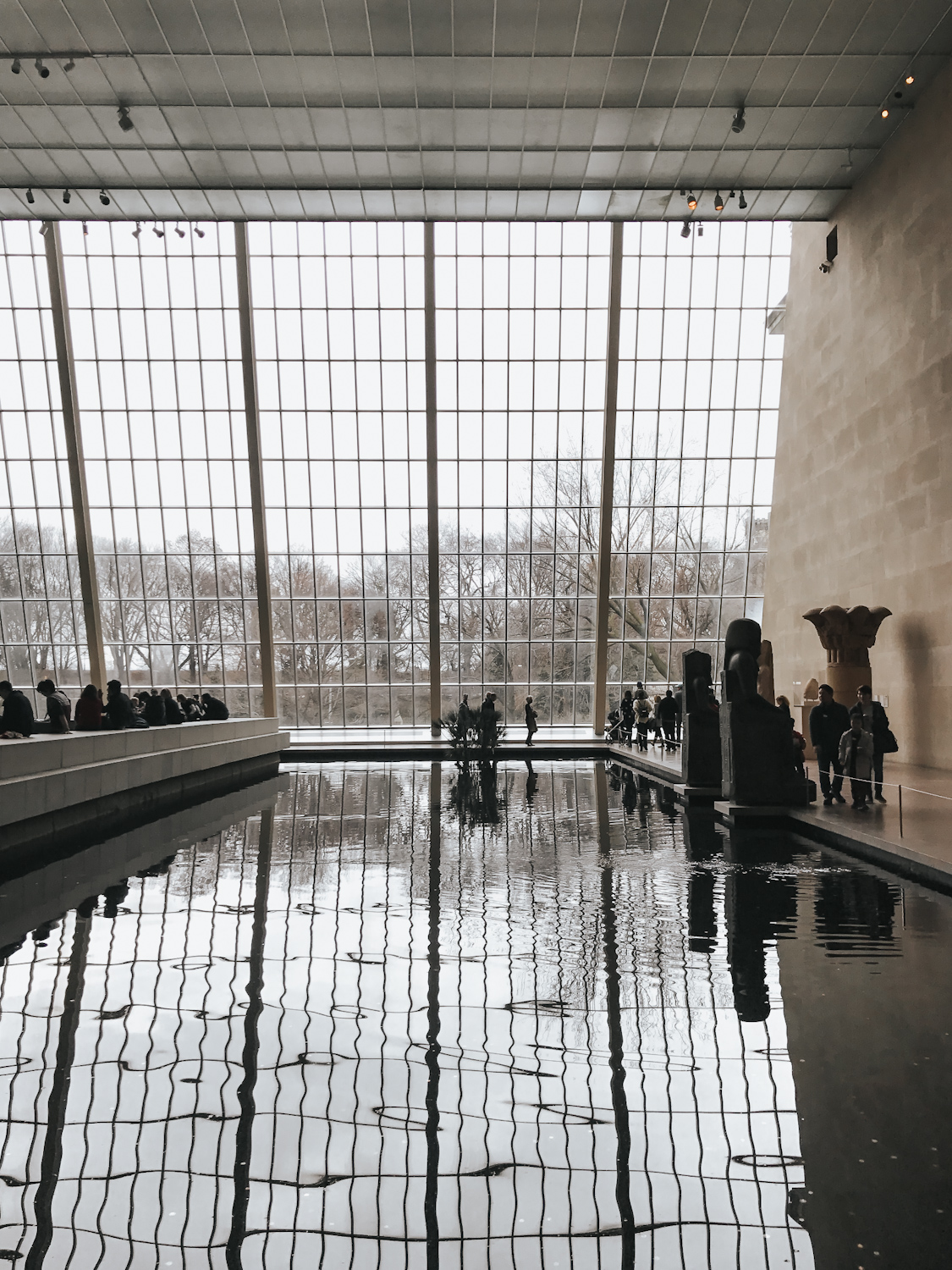 Metropolitan Museum of Art Egyptian wing interior with reflecting pool and floor to ceiling windows overlooking Central Park